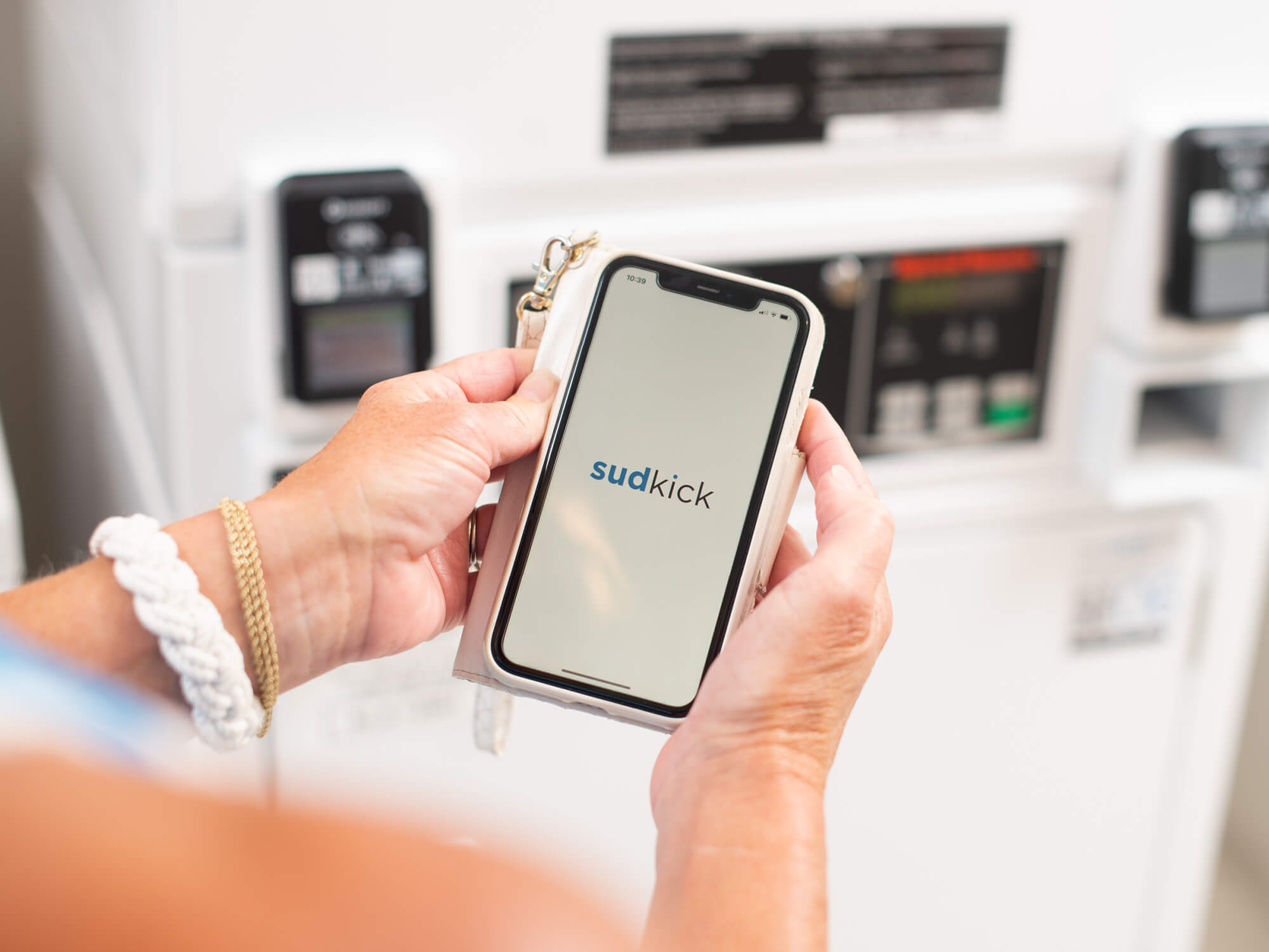 Photo of guest using a mobile aoo to pay for laundry