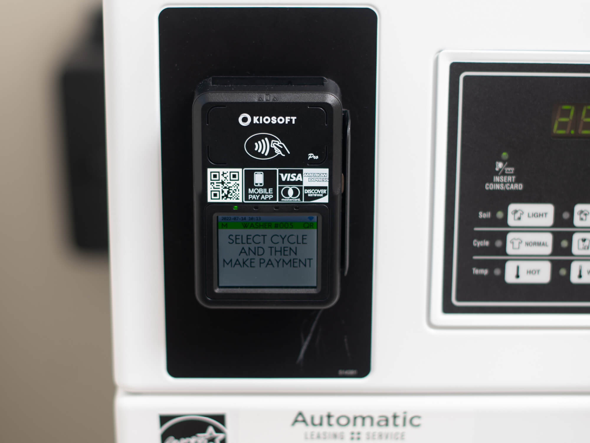 Photo of convenient credit card payment device on washing machine