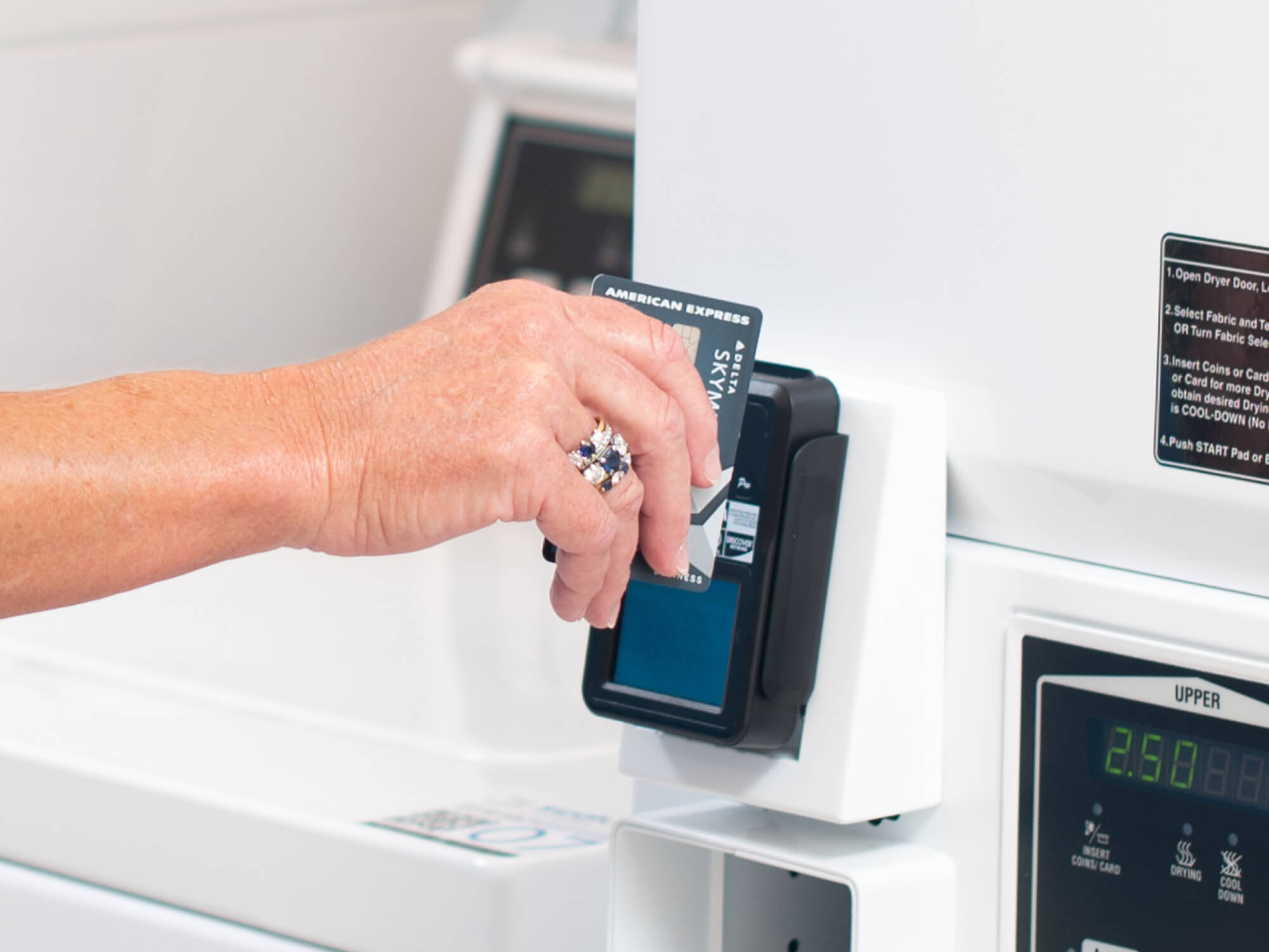 Photo of guest paying for their laundry with a credit card