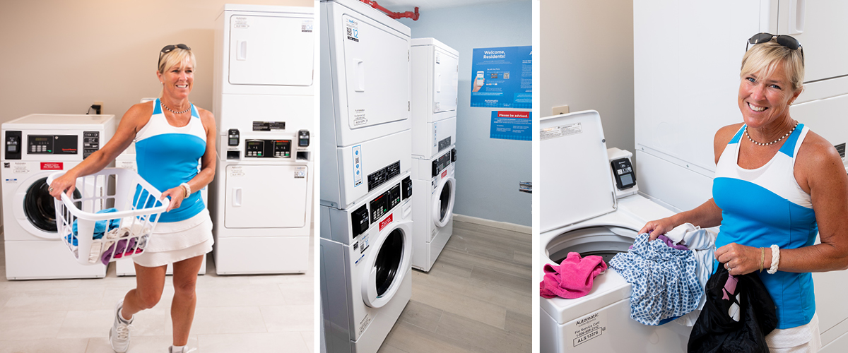 Hotel guest doing laundry while smiling.